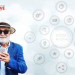 Elderly man with phone and social media icons around him